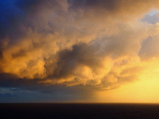 Obraz premium Storm Front Into Sunrise Over Ocean