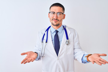 Young doctor man wearing stethoscope over isolated background clueless and confused with open arms, no idea concept.