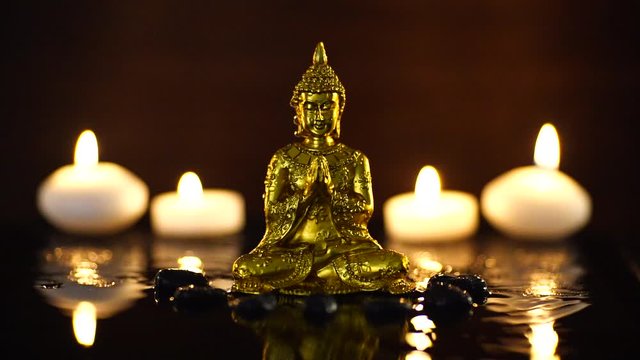仏像とキャンドルと水面に落ちる滴の動画