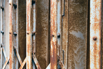 Rusty collapsible steel door. Old fashion style shutter gate. 