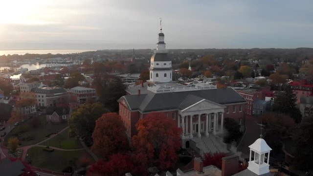 An aerial drone shot flies toward the Maryland Statehouse Capitol Building, Annapolis and the Chesapeake bay.
