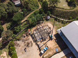 Asian worker with concrete lift crane and cement mixer truck