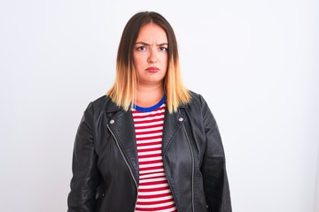 Young beautiful woman wearing striped shirt and jacket over isolated white background skeptic and...