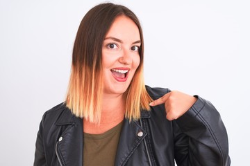 Young beautiful woman wearing t-shirt and jacket standing over isolated white background with surprise face pointing finger to himself