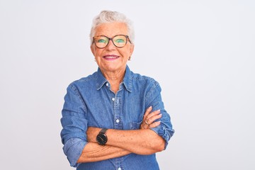 Senior grey-haired woman wearing denim shirt and glasses over isolated white background happy face...