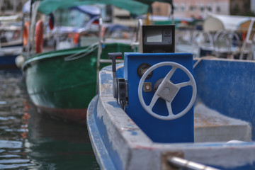 Fototapeta na wymiar Dashboard and steering wheel of an old motor boat.