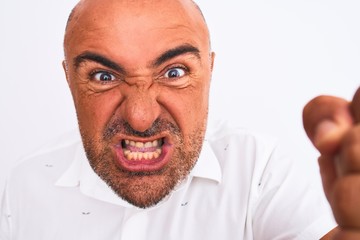 Middle age handsome man wearing elegant shirt standing over isolated white background annoyed and frustrated shouting with anger, crazy and yelling with raised hand, anger concept