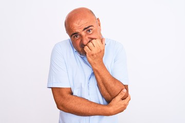 Middle age handsome man wearing casual shirt standing over isolated white background looking stressed and nervous with hands on mouth biting nails. Anxiety problem.