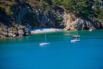 Fototapeta na wymiar Incredible landscape with yachts near Virgin Island's Beach. Crozon Peninsula. Finister. Brittany. France