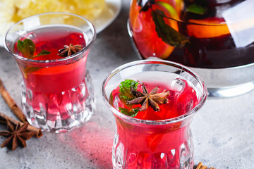 Oriental berry red tea with spices on wooden table background