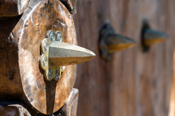 Ancient traditional wooden carved door with ornaments and bronze spike in Stone Town on island Zanzibar, Tanzania, East Africa