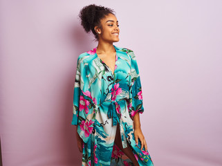 Young beautiful african american woman standing wearing elegant colorful caftan