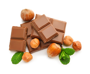 Tasty chocolate with hazelnuts on white background