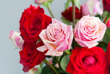 Rose petal detail, romantic floral arrangement made with roses grown in Guatemala, natural and artificial light in vase, home interior.