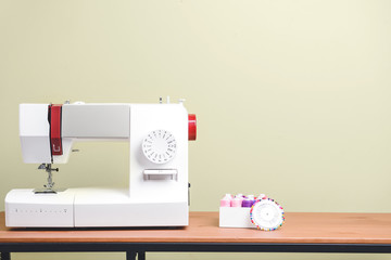 Sewing machine with supplies on table