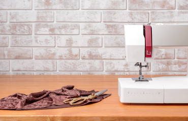 Sewing machine with supplies on table
