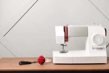 Sewing machine with supplies on table