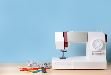 Sewing machine with supplies on table