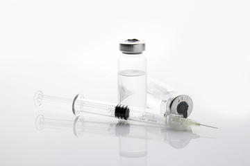 Syringe and ampules with filler for cosmetology on white background