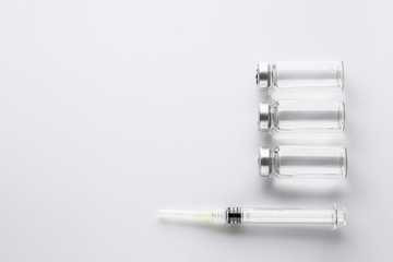 Syringe and ampules with filler for cosmetology on white background