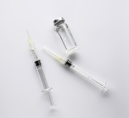 Syringes and ampule with filler for cosmetology on white background