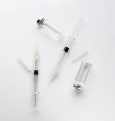 Fototapeta premium Syringes and ampules with filler for cosmetology on white background