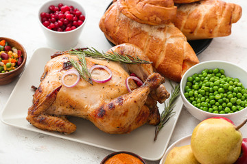 Tasty baked turkey and other dishes for Thanksgiving day on table