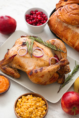 Tasty baked turkey and other dishes for Thanksgiving day on table