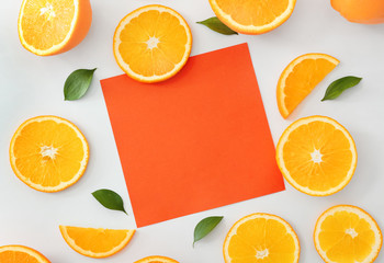 Sweet oranges and blank paper on white background