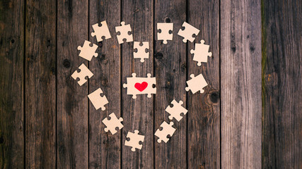 Red heart puzzle together. Concept of Valentine's day. Selective focus. Love. Divorce. Broken heart. The reunion of the lovers. How to find your soul mate in love?