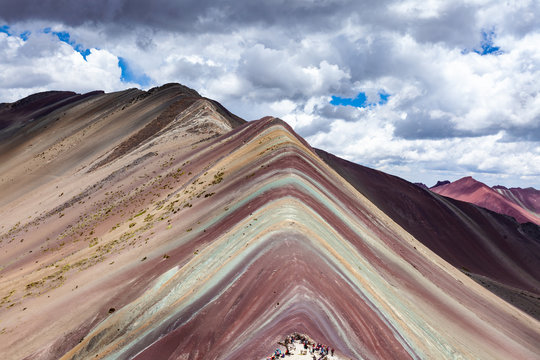 Close-up view of Rainbow Mountains Of Peru Peruvian Andes. Ausangate mountain. Bright colors and beautiful clouds.