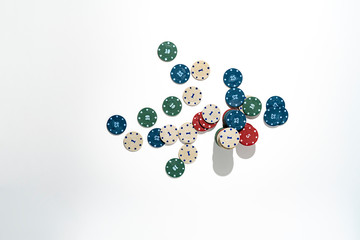 top view bunch of poker chips drop on colorful table, winning the holdem in casino, minimalist