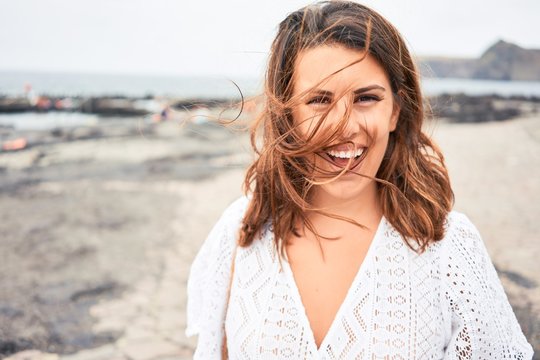 Young beautiful woman smiling happy enjoying summer vacation at black sand beach at Canary Islands