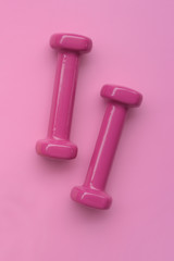 close up of dumbbell on pink background