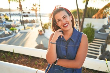 Fototapeta premium Young beautiful woman smiling happy walking on city streets of Puerto de la Cruz, Tenerife on a sunny day of summer