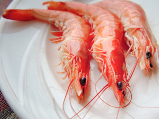 Delicious boiled shrimps served on plate, fresh shrimps cooked seafood in seafood restaurant.
