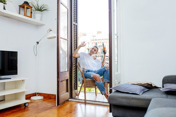 Young adult beautiful girl in casual clothes at home with a drink in a bottle