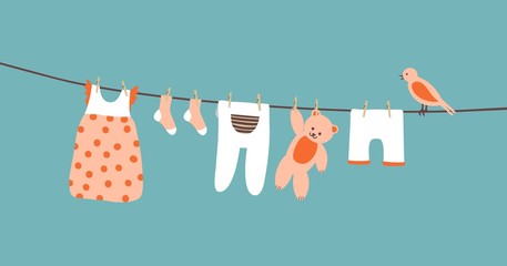 Baby clothes on clothesline hanging and drying. Clean apparel on a rope. Colorful vector illustration on blue