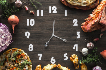 Food clock on the Black wood Laminate, Concept time to eat.