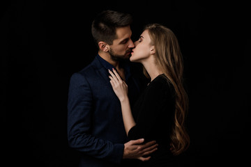 elegant couple in the tender passion. man and beautiful woman kissing