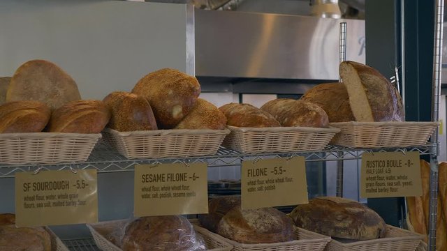 Panning shot of different types of bread.Slowed to half speed.