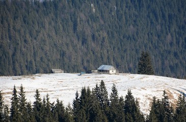 a hut on an alpine meadow in winter