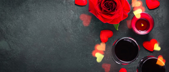 Valentines day concept. Wine glasses, rose and hearts bokeh lights. Banner format