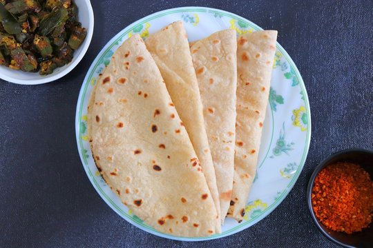 Fresh Indian flat bread chapati or Roti along with Okra fry and spicy red peanut garlic chutney