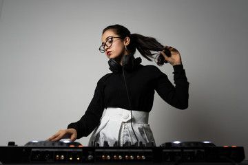 Beautiful DJ girl on decks on the party