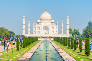 Colorful crowds of visitors walking along the Taj Mahal complex