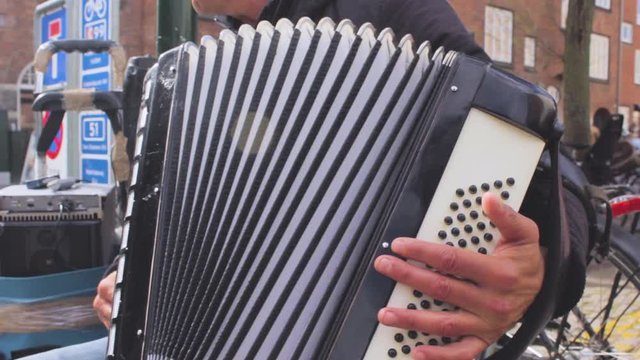 Close-up shot of a street musician's hand playing the accordion. Copenaghen, Denmark