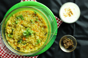 Selected Focus on Famous Popular Indian Masala Khichadi Or Dal Khichadee Made Of Rice Lentils and Green Vegetables With Curd and Pickles