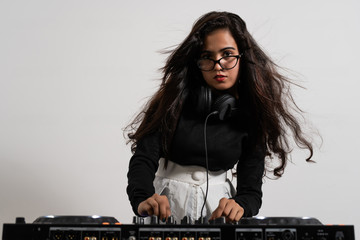 Beautiful DJ girl on decks on the party