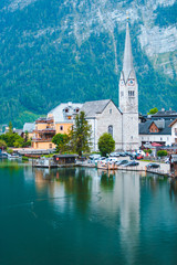 Evangelical hallstatt church at lake shore alps mountains on background